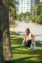 Woman Cleaning Droppings Of Her French Poodle Dog Royalty Free Stock Photo