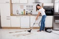 Woman Cleaning The Dust Floor Of The Kitchen Royalty Free Stock Photo