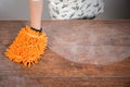 Woman cleaning dusty table