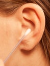 Woman cleaning ear with cotton swabs closeup Royalty Free Stock Photo