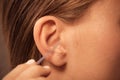 Woman cleaning ear with cotton swabs closeup Royalty Free Stock Photo