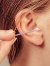 Woman cleaning ear with cotton swabs closeup Royalty Free Stock Photo