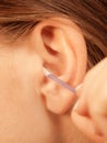 Woman cleaning ear with cotton swabs closeup Royalty Free Stock Photo