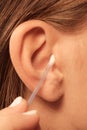 Woman cleaning ear with cotton swabs closeup Royalty Free Stock Photo