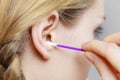 Woman cleaning ear with cotton swabs closeup Royalty Free Stock Photo