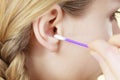 Woman cleaning ear with cotton swabs closeup Royalty Free Stock Photo