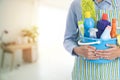 Woman with cleaning equipment ready to clean house on living room blur background Royalty Free Stock Photo