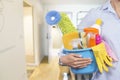 Woman with cleaning equipment ready to clean house