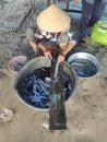 woman cleaning fish in La Gi, Vietnam