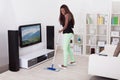 Woman Cleaning Floor In Living Room Royalty Free Stock Photo