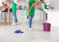 Woman cleaning floor with mop in kitchen Royalty Free Stock Photo