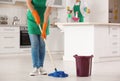 Woman cleaning floor with mop in kitchen Royalty Free Stock Photo