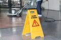 Woman cleaning the floor with polishing machine