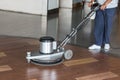 Woman cleaning the floor with polishing machine Royalty Free Stock Photo