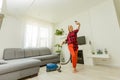 Woman cleaning floor vacuum cleaner in the modern white living room Royalty Free Stock Photo