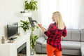 Woman cleaning floor vacuum cleaner in the modern white living room Royalty Free Stock Photo