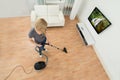 Woman Cleaning Floor With Vacuum Cleaner Royalty Free Stock Photo