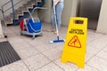 Woman Cleaning Floor With Wet Floor Caution Sign Royalty Free Stock Photo
