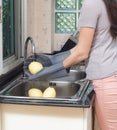 Woman cleaning fruits in the kitchen