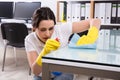 Woman Cleaning The Glass Office Desk With Rag Royalty Free Stock Photo