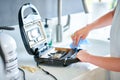 Woman cleaning grill or toaster machine in the kitchen