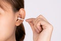 Woman cleaning her ear with a cotton swab. A woman suffered an infection after using the sticks incorrectly