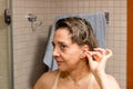 Woman Cleaning her Ears with a Cotton Tip Swab Royalty Free Stock Photo