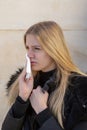 Woman cleaning her nose in winter