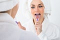 Woman cleaning her tongue Royalty Free Stock Photo