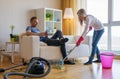 Woman cleaning home and man doesn`t help her