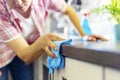 Woman Cleaning Kitchen Counter with Blue Cloth Royalty Free Stock Photo