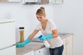 Woman Cleaning Kitchen Counter With Sponge Royalty Free Stock Photo