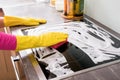 Woman cleaning kitchen stove