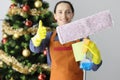 Woman cleaning lady showing thumb up and holding mop near new year tree closeup Royalty Free Stock Photo