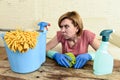 Woman cleaning living room table with cloth and spray bottle tired in stress