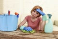 Woman cleaning living room table with cloth and spray bottle tired in stress Royalty Free Stock Photo