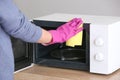 Woman cleaning microwave oven in kitchen Royalty Free Stock Photo