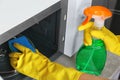 Woman cleaning microwave oven with sponge Royalty Free Stock Photo