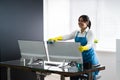 Woman Cleaning Office Desk And Computer Monitor Royalty Free Stock Photo