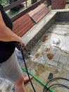 Woman Cleaning outside floor with water pressure cleaner Royalty Free Stock Photo