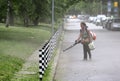 Woman cleaning park footpath