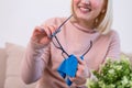 Woman cleaning reading glasses with cloth. Women hand cleaning glasses lens with blue cloth Royalty Free Stock Photo