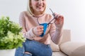 Woman cleaning reading glasses with cloth. Women hand cleaning glasses lens with blue cloth Royalty Free Stock Photo