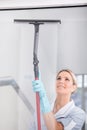 Woman Cleaning With Rubber Window Cleaner Royalty Free Stock Photo