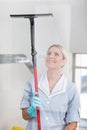 Woman cleaning with rubber window cleaner Royalty Free Stock Photo