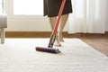 Woman cleaning rug carpet with vacuum cleaner at home Royalty Free Stock Photo