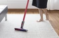 Woman cleaning rug carpet with vacuum cleaner at home Royalty Free Stock Photo