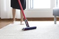 Woman cleaning rug carpet with vacuum cleaner at home Royalty Free Stock Photo