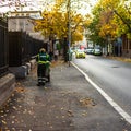 Woman cleaning the sidewalk in downtown Bucharest, Romania, 2019 Royalty Free Stock Photo