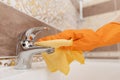 Woman cleaning tap from limescale bathroom sink close-up Royalty Free Stock Photo